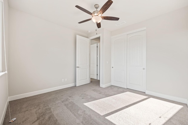 unfurnished bedroom with ceiling fan, a closet, and light colored carpet