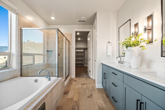 bathroom with an enclosed shower and vanity