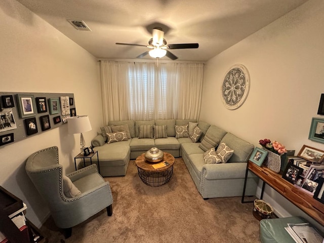 carpeted living room with ceiling fan