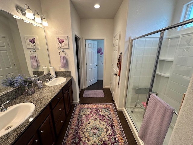 bathroom featuring hardwood / wood-style flooring, walk in shower, and vanity