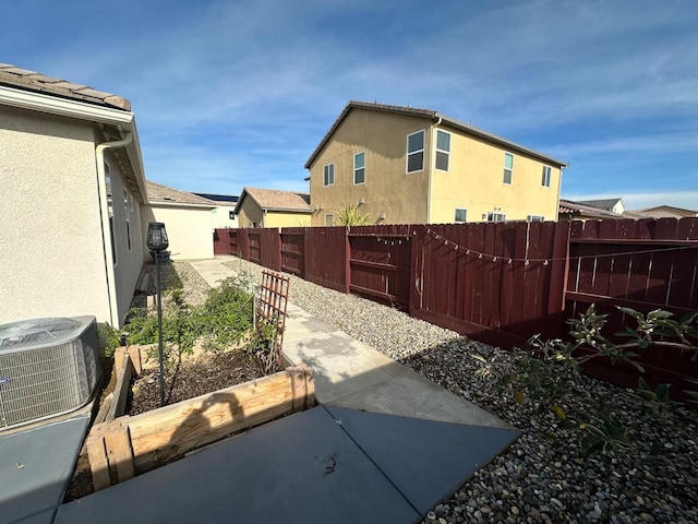 view of yard with cooling unit and a patio area