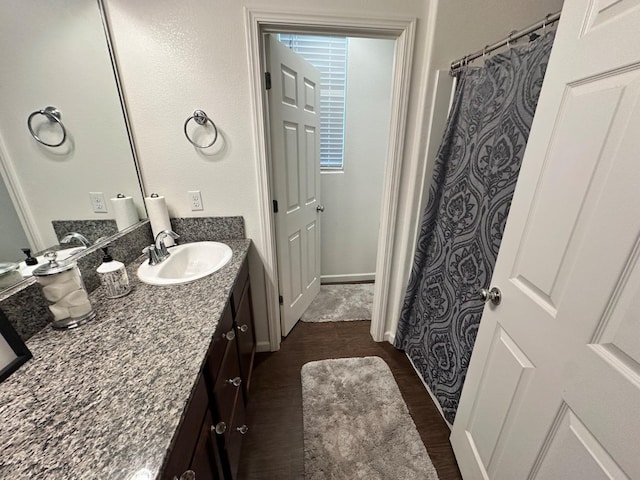 bathroom featuring hardwood / wood-style flooring and vanity