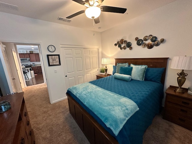 carpeted bedroom with ceiling fan and a closet