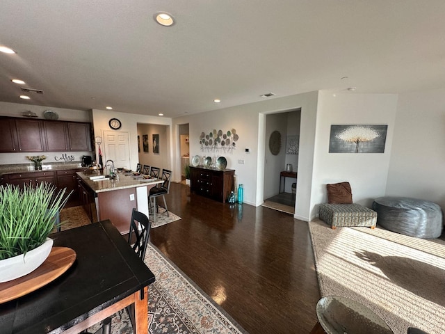 living room featuring dark hardwood / wood-style flooring and sink