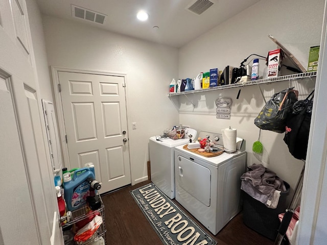 laundry area featuring washer and clothes dryer and dark hardwood / wood-style floors