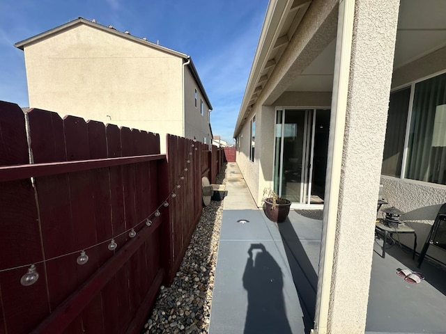 view of side of property with a patio area