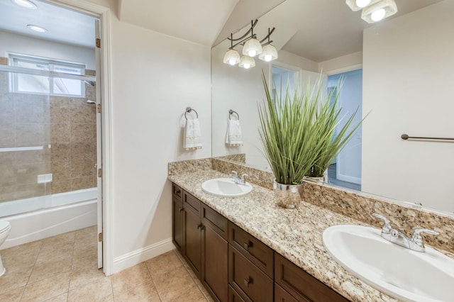 full bath with tile patterned flooring, a sink, baseboards, and double vanity