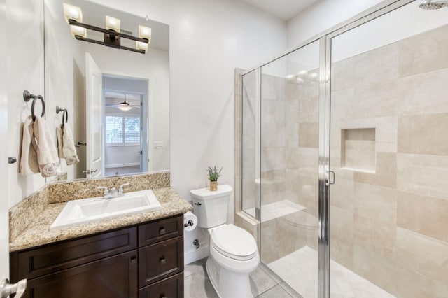 full bathroom with toilet, a shower stall, baseboards, and vanity