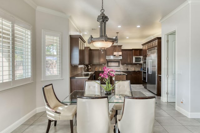 dining space with ornamental molding and light tile patterned floors