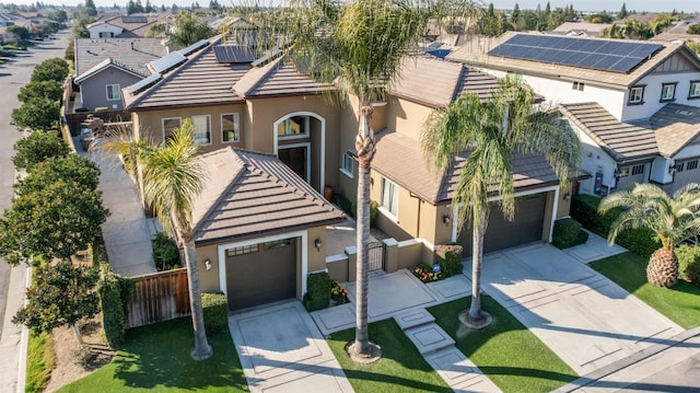 view of front of property with a tiled roof, driveway, a residential view, and stucco siding