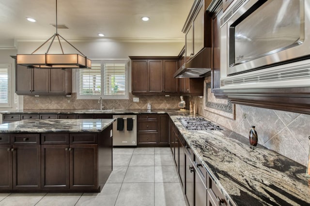 kitchen featuring dark stone counters, stainless steel appliances, tasteful backsplash, and crown molding