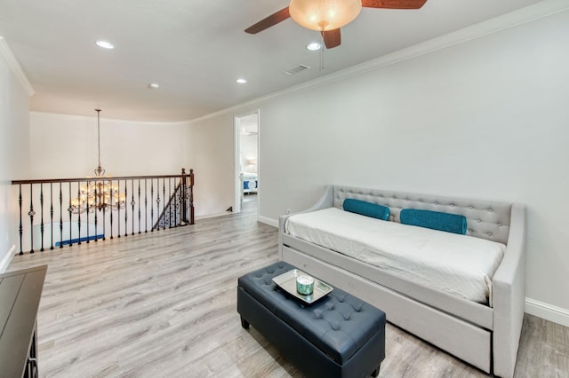 living area featuring an upstairs landing, crown molding, baseboards, and wood finished floors