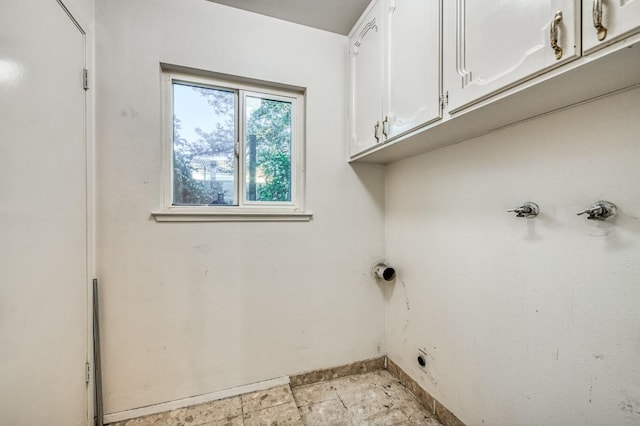 laundry room featuring cabinets