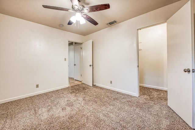 unfurnished bedroom featuring ceiling fan and light colored carpet