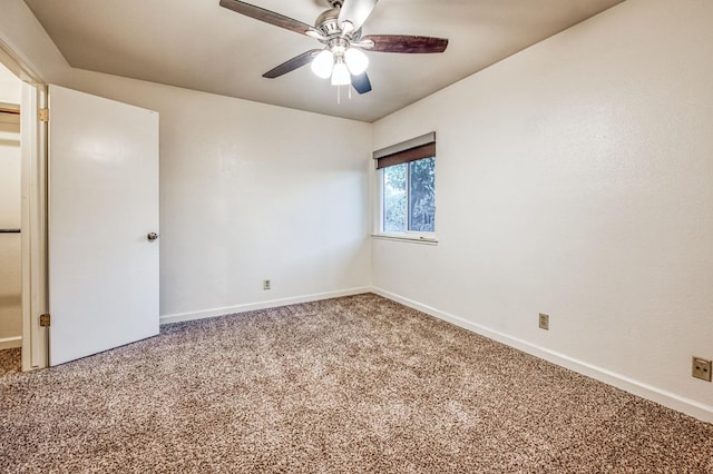 carpeted empty room featuring ceiling fan