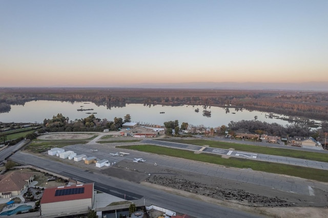 aerial view at dusk with a water view