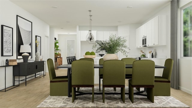 dining space with light wood finished floors