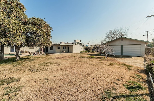 view of yard with a garage and an outdoor structure