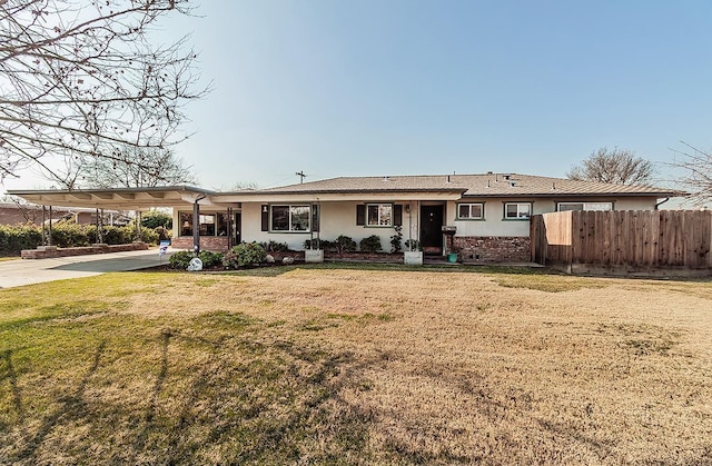 view of front facade with a front yard and a carport