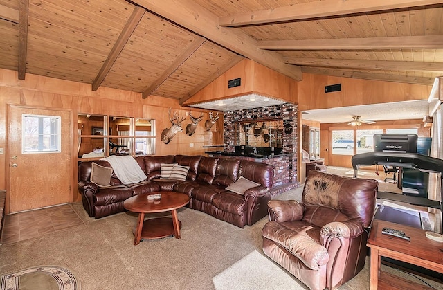 carpeted living room with wooden ceiling, ceiling fan, vaulted ceiling with beams, and wooden walls