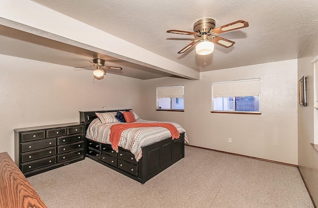 carpeted bedroom with a textured ceiling and ceiling fan