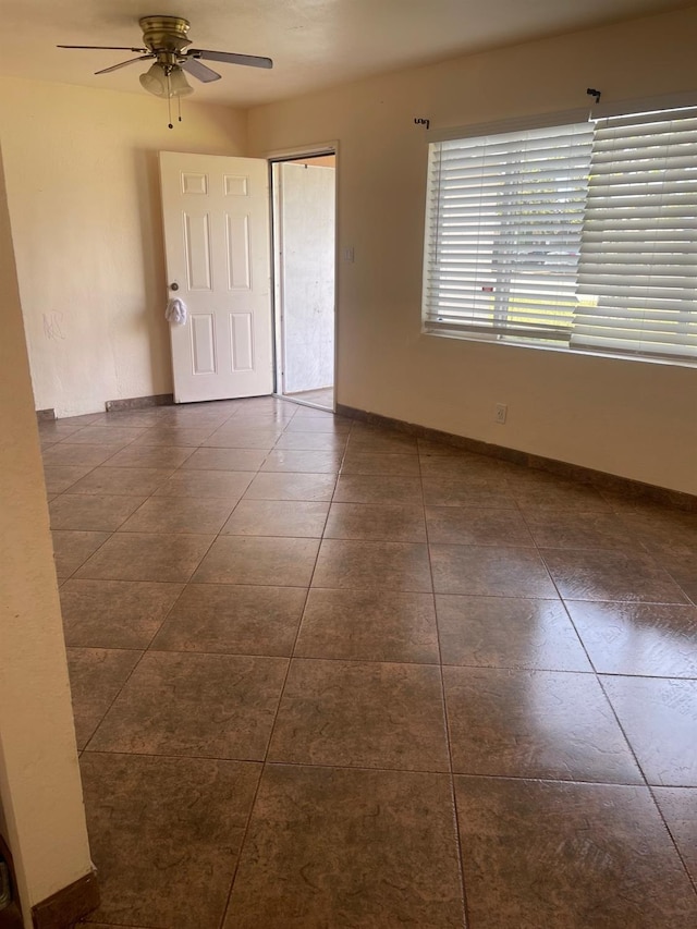 tiled empty room with ceiling fan