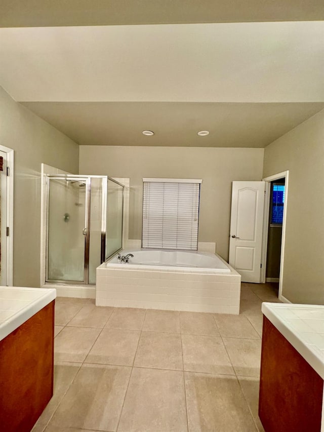 bathroom featuring tile patterned floors, vanity, and separate shower and tub