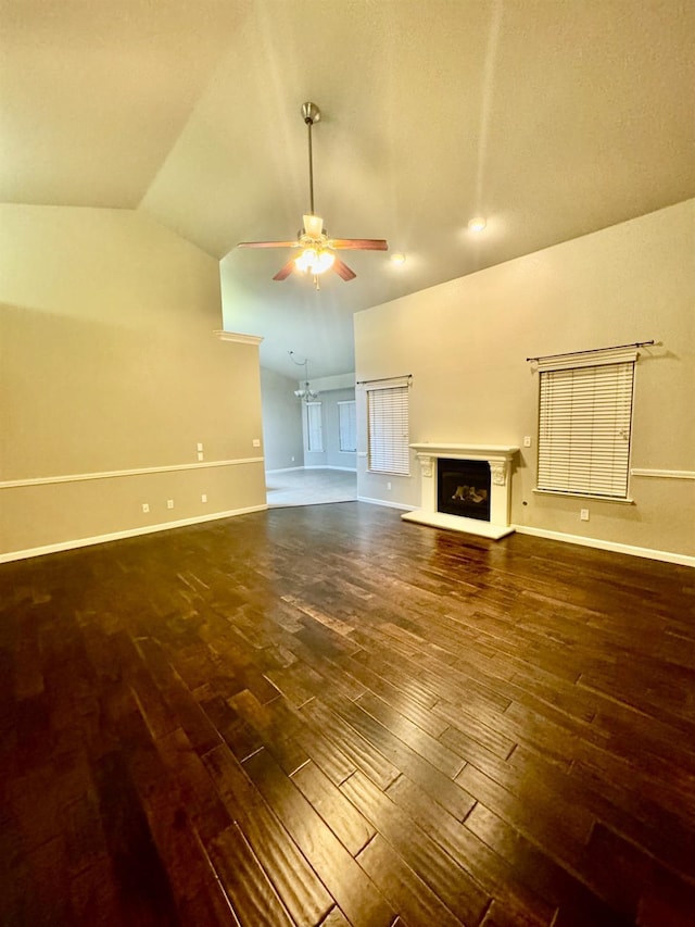 unfurnished living room with ceiling fan, dark hardwood / wood-style floors, and vaulted ceiling