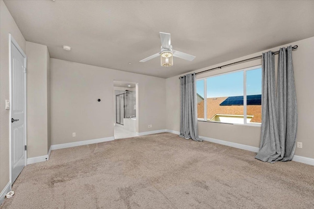 empty room with light colored carpet and ceiling fan