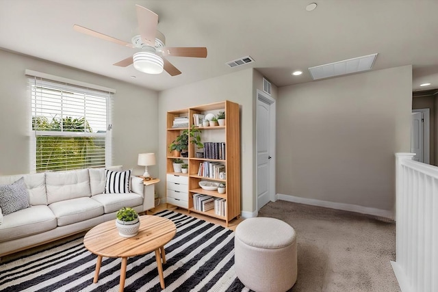 carpeted living room featuring ceiling fan