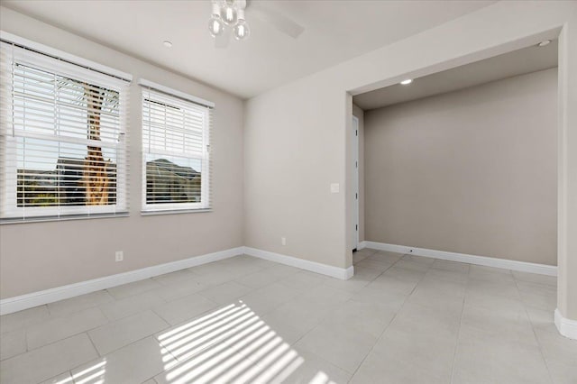 tiled empty room with ceiling fan