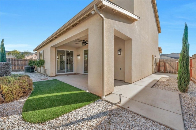 back of house featuring central AC unit, a patio area, and ceiling fan