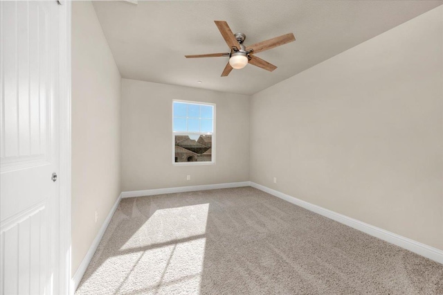 spare room featuring light carpet and ceiling fan