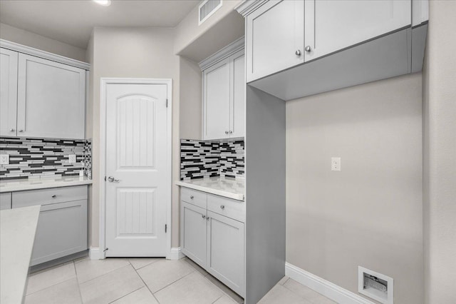 kitchen with light tile patterned flooring and decorative backsplash