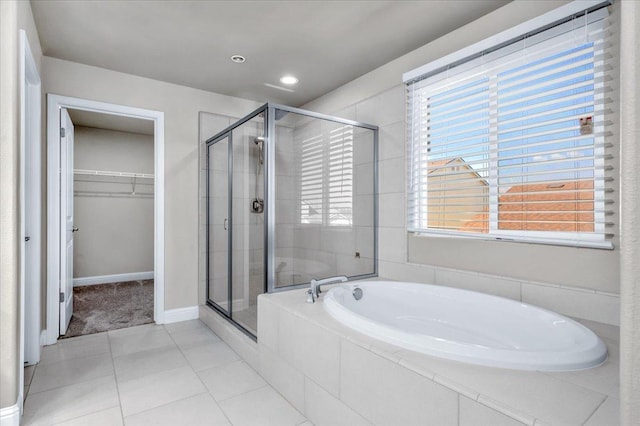 bathroom with independent shower and bath, plenty of natural light, and tile patterned flooring