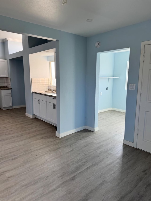 interior space with wood finished floors and baseboards