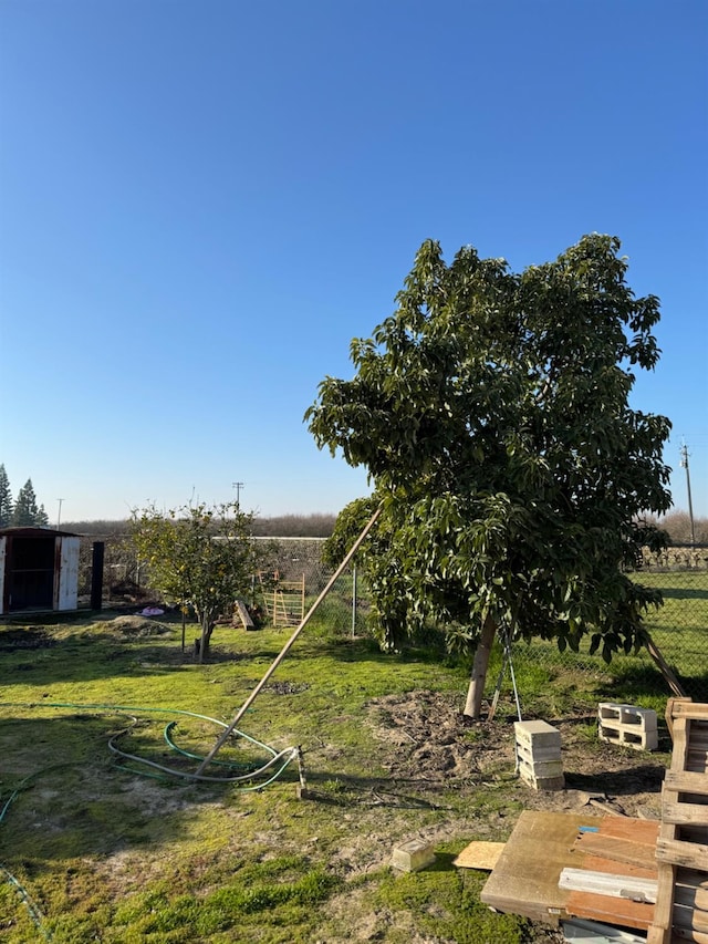 view of yard with a rural view and fence