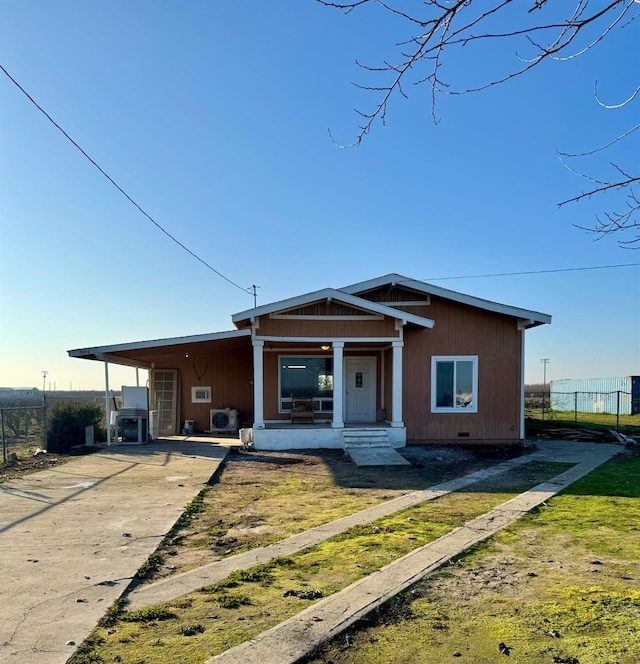 view of front of property with crawl space, concrete driveway, and fence