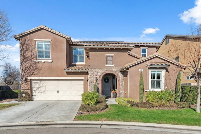 mediterranean / spanish-style home with a garage and a front lawn