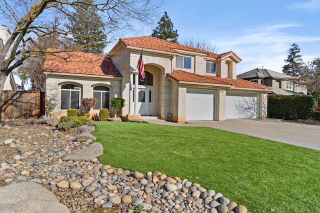 mediterranean / spanish home with a garage and a front lawn