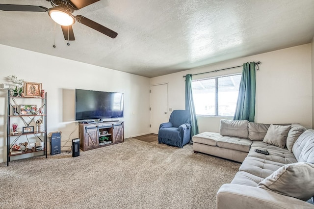 living room with ceiling fan, a textured ceiling, and carpet flooring