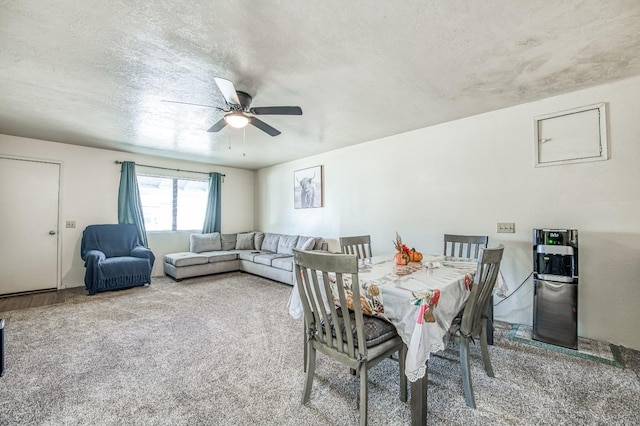 dining space featuring carpet and ceiling fan