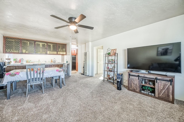 dining area featuring ceiling fan, carpet flooring, bar, and a textured ceiling