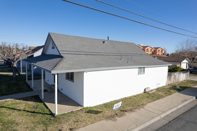 view of side of property with a lawn and a patio