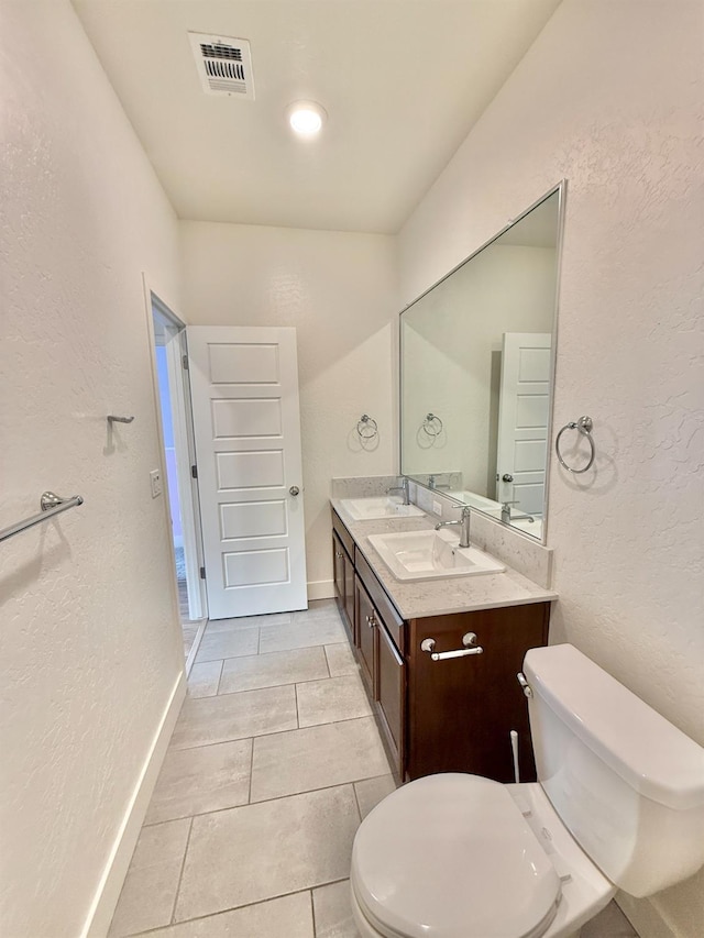 bathroom with vanity, tile patterned floors, and toilet