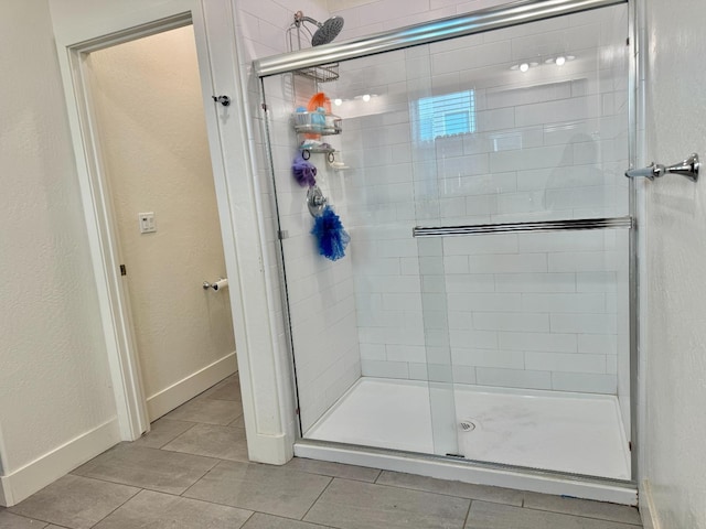 bathroom featuring tile patterned flooring and a shower with door