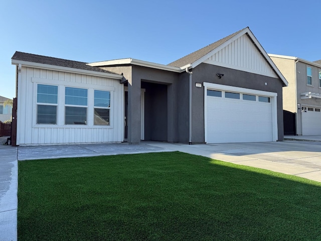 view of front of home featuring a garage and a front lawn