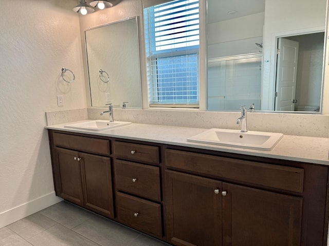 bathroom with vanity, an enclosed shower, and tile patterned floors