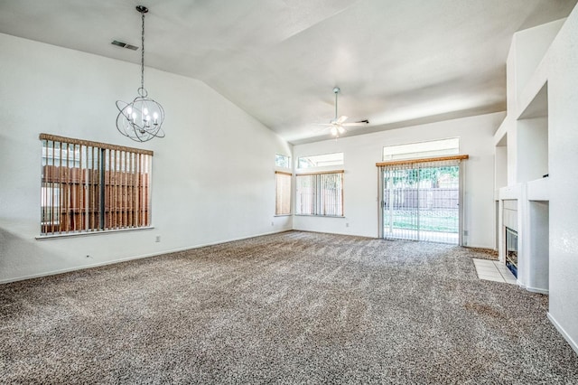 unfurnished living room featuring ceiling fan with notable chandelier, lofted ceiling, and light carpet