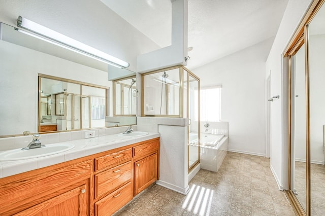 bathroom with shower with separate bathtub, a wealth of natural light, and vanity